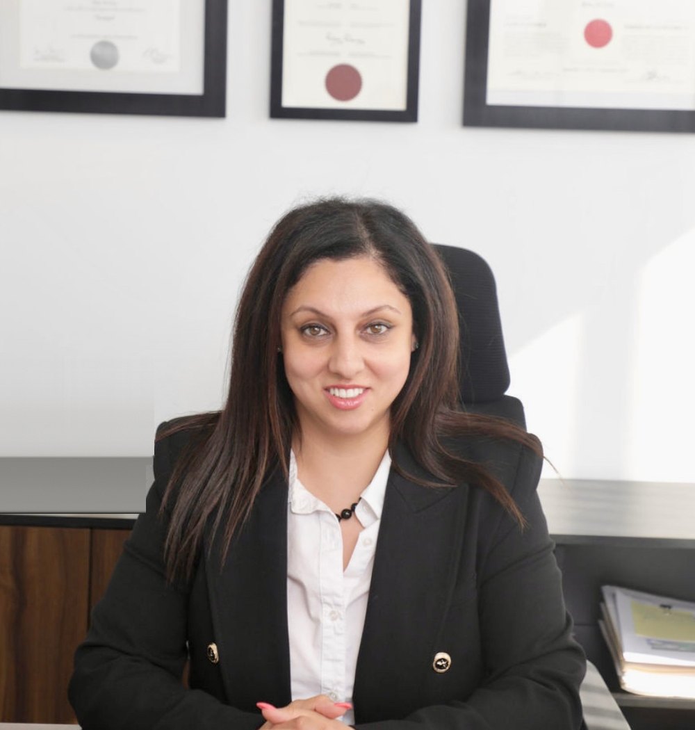 Bita Di Lisi, lead paralegal for Greater Sudbury landlords, at her desk in the Stonegate office