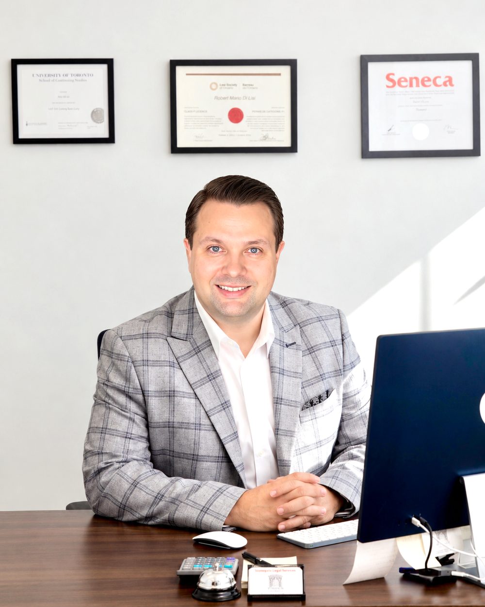 Robert Di Lisi, Brantford landlord paralegal, at his desk in the Stonegate office